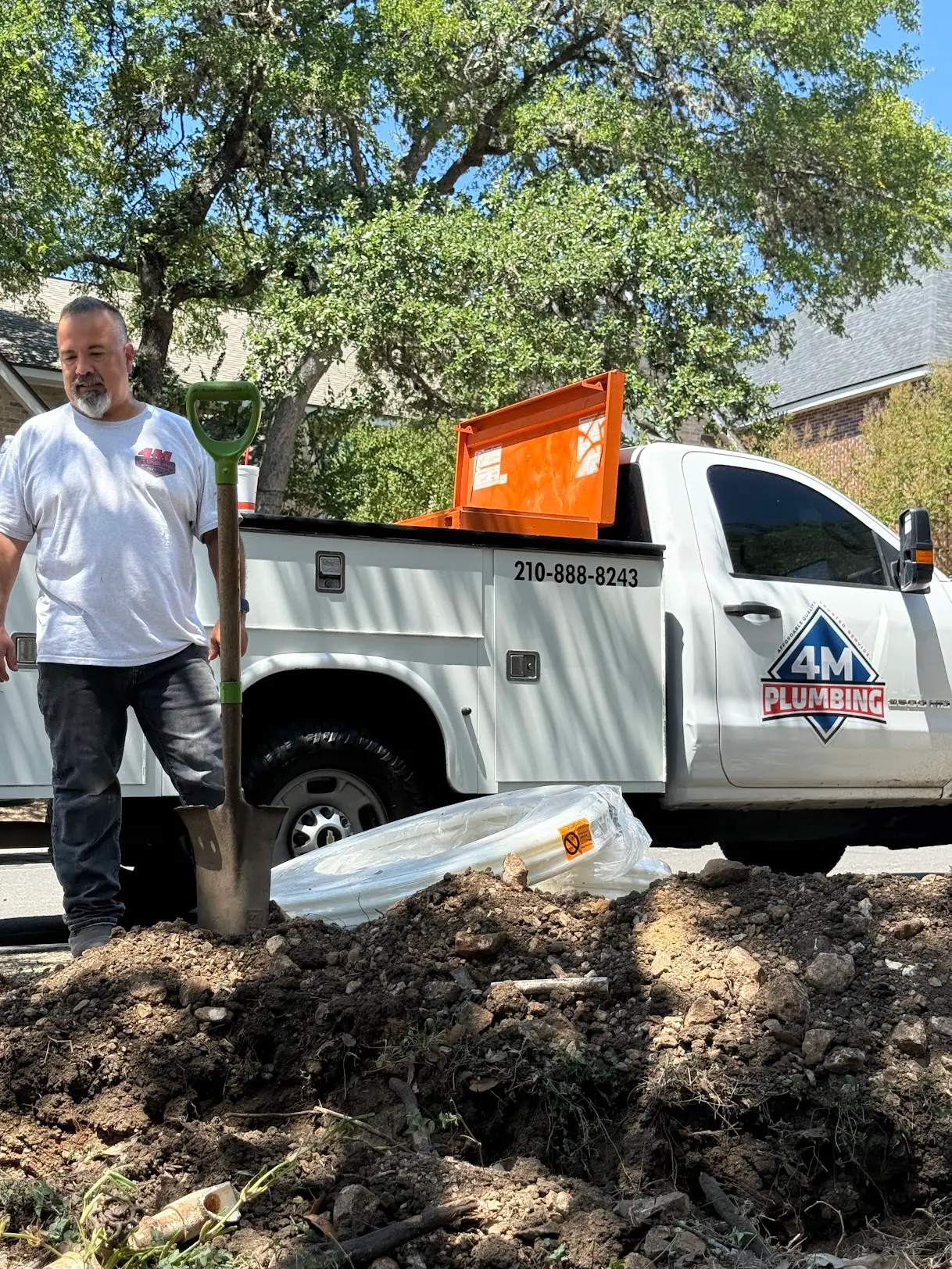 4M Plumbing Services plumber with the 4M truck on a San Antonio job